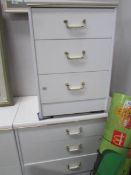 A white 3 drawer chest and a bedside