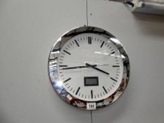 A modern chrome wall clock