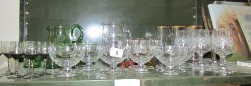 A shelf of assorted drinking glasses