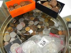 A tin of UK and foreign coins including commemorative crowns,