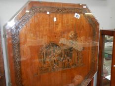 An oriental tilt top table with carved top
