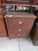 A glass topped bedside chest