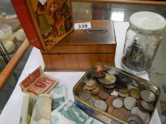 A box of miscellaneous items including money box