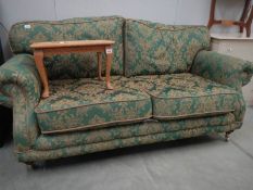 A green brocade sofa