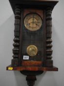 A Victorian walnut cased wall clock with turned columns