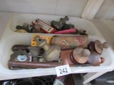 A box of mixed items including door knobs