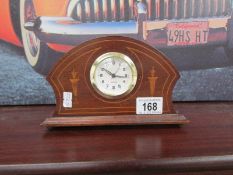 A small mahogany inlaid mantel clock