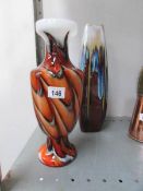 A tall pottery vase and a coloured glass vase