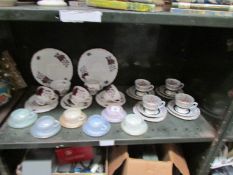 A shelf of assorted tea ware