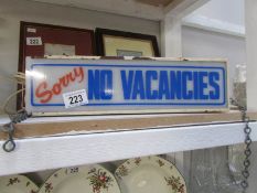 A vintage illuminated 'Sorry No Vacancies' hotel B & B sign
