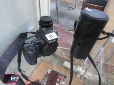 A Canon digital camera and 2 lenses