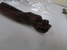 An oriental carved wood scoop