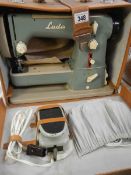 A cased vintage LADA sewing machine