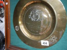A framed brass plaque