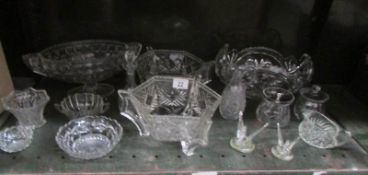 A shelf of assorted glass ware