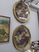 A pair of oval gilt framed and glazed floral prints