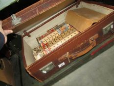 A vintage suitcase containing vintage wooden toys