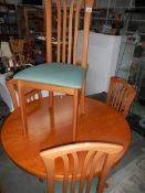 A teak dining table and 4 chairs