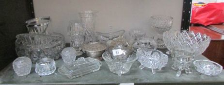 A shelf of assorted glass ware