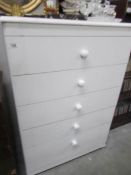 A white 5 drawer chest