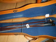 A violin case & 3 violin bows