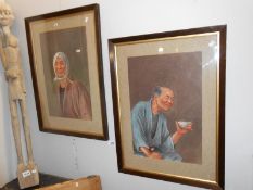 A pair of framed and glazed portrait paintings,