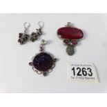 A silver and Druzy quartz pendant with amethysts, a pair of silver and garnet earrings,