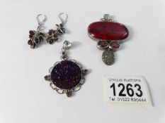 A silver and Druzy quartz pendant with amethysts, a pair of silver and garnet earrings,