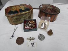 2 vintage tins and contents including badges, pins,