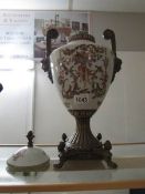 An ornate metal and ceramic lidded urn (lid knob a/f)