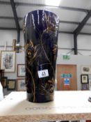A tall art pottery vase