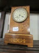 A marquetry inlaid mantel clock