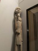 Tribal Art - a tall carved figure of a man holding items (missing), early 20th century,