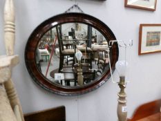 An oval framed mirror