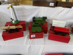 A boxed Hornby 0 gauge locomotive and tender, a cement wagon, a lumber wagon,