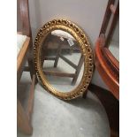 An oval gilt framed mirror