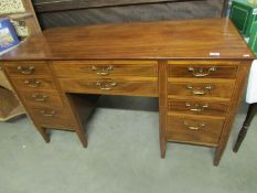 An inlaid mahogany desk with 9 drawers and 1 cupboard (key in office)