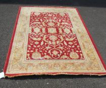A red and beige rug,