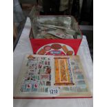 A quantity of used world stamps and an album of stamps