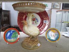 A Royal Worcester comport on pheasant base and hand painted with roses (slight repair to rim) circa