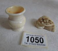 An ivory netsuke of a crab and a small pot