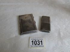 A silver cigarette lighter and a silver cigarette case
