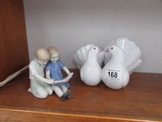 A Lladro dove group and another figure of a boy and girl