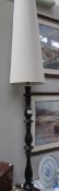 A tall table lamp with shade