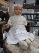 An early 20th century doll with working squeaker