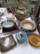 A mixed lot of art pottery including teapots,