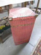 A Lloyd Loom linen bin