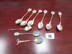 A set of 6 enamelled souvenir spoons and three others