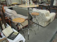 A breakfast table and pair of bar stools