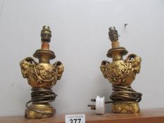 A pair of table lamp bases featuring rams heads